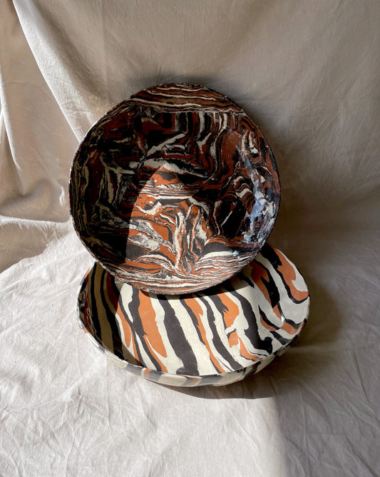 Two marbled ceramic bowls from the Ardi collection with earthy hues and a clear glaze coating