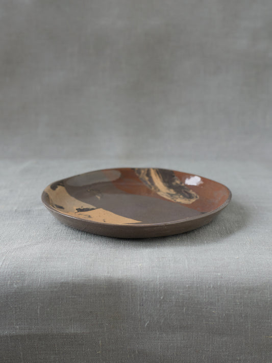 handmade ceramics, small marbled dinner plate, profile angle